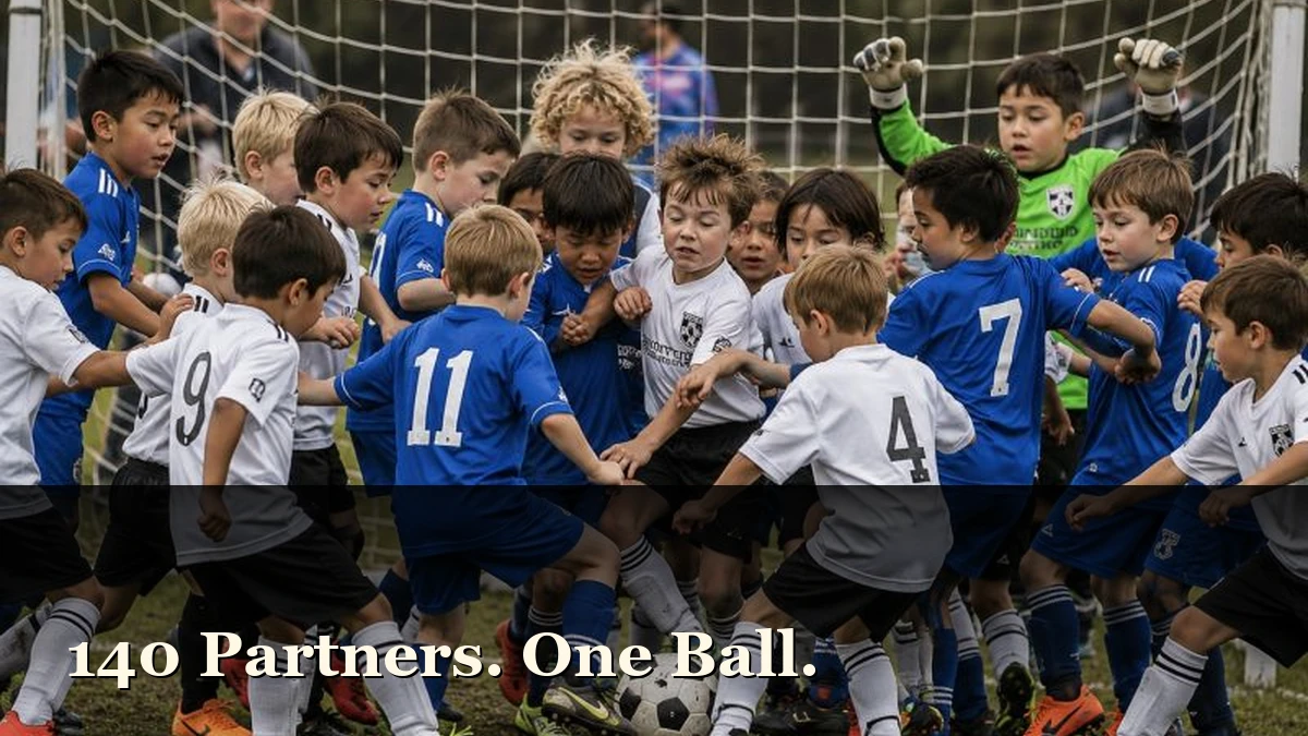 A swarm of under-six footballers in blue and white kits all chasing one ball